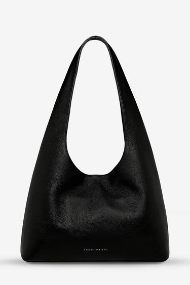 Black leather handbag on a light gray background