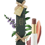 Luk Beautyfood No.06 Nude Lipstick shown with its dark green gift box decorated with gold stars, a beige ribbon, and botanical illustrations, alongside the lipstick tube and two lipstick color swatches on a white background.