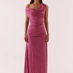 Woman wearing a pink polka dot dress on a white background