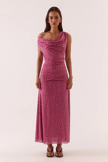 Woman wearing a pink polka dot dress on a white background
