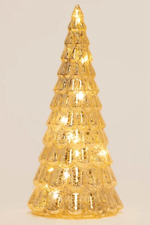 A small, textured gold Christmas tree light with warm white LED lights glowing inside, set against a plain light beige background.