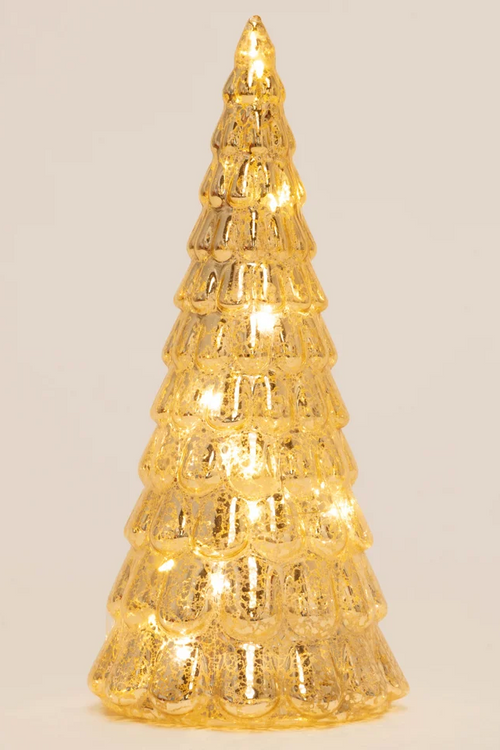 A small, textured gold Christmas tree light with warm white LED lights glowing inside, set against a plain light beige background.