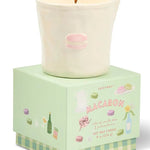 Candle in a decorative box with 'Macaron' branding on a white background