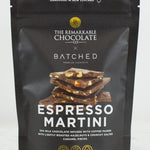 A 150g stand-up pouch of 'The Remarkable Chocolate x Batched' Espresso Martini chocolate, featuring a dark brown background with gold accents and a graphic of chocolate pieces.