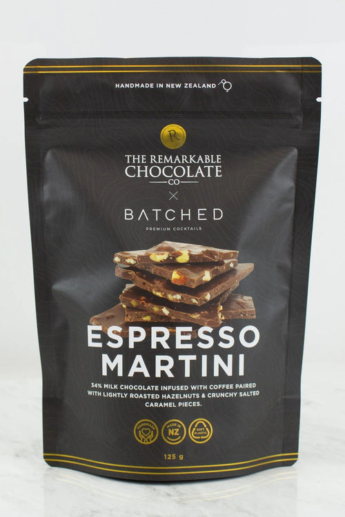 A 150g stand-up pouch of 'The Remarkable Chocolate x Batched' Espresso Martini chocolate, featuring a dark brown background with gold accents and a graphic of chocolate pieces.