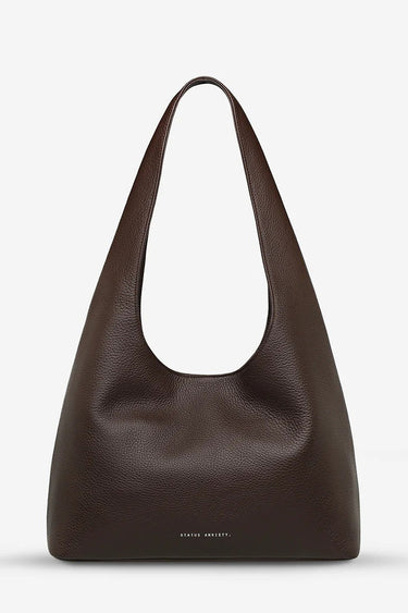 Brown leather shoulder bag on a light gray background