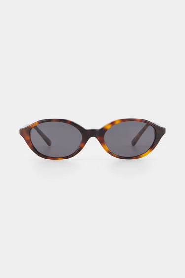 Sunglasses with tortoiseshell frame and dark lenses on a white background