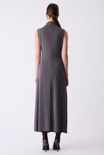 Woman wearing a long dark gray dress on a white background