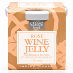 A box of Crave Food Rosé Wine Jelly, featuring a warm peach and brown patterned design with a white central label. The packaging includes a silver metal tab on top and is labeled 'Indian Summer Rose' with a volume of 120 ml.