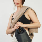 model wears a black bucket bag