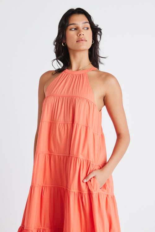 model in orange maxi dress