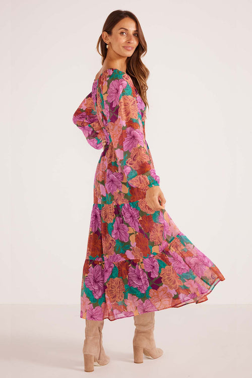 model wears a pink floral maxi dress