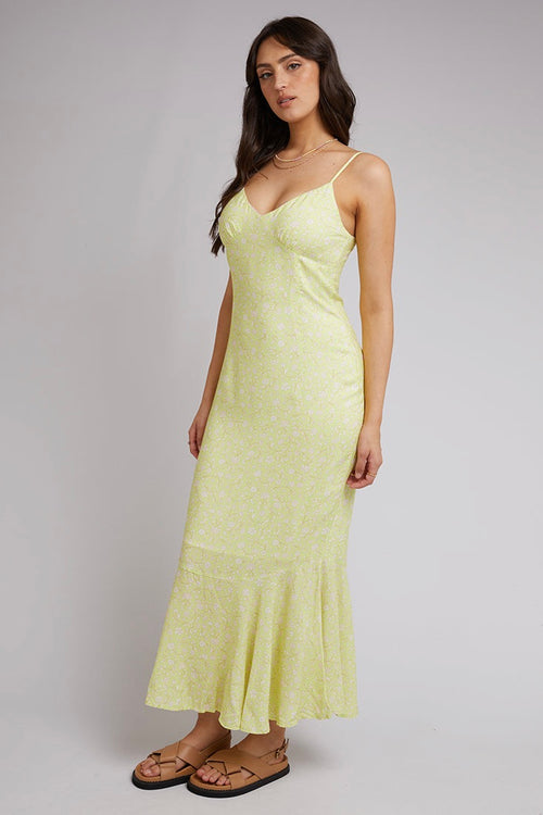 model wears a yellow floral dress