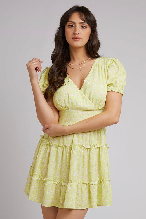 model wears a yellow floral mini dress