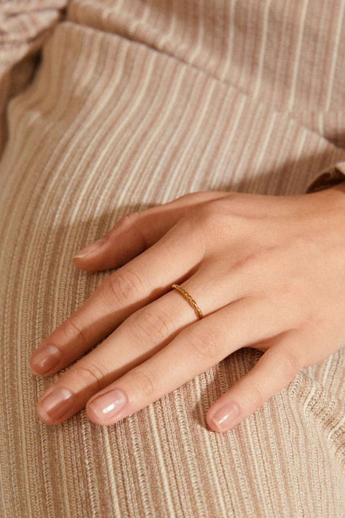 model wears a gold ring