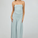 woman wears a blue ruched maxi dress