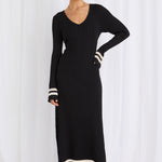 Model wears a long sleeve black maxi dress