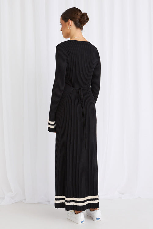 Model wears a long sleeve black maxi dress