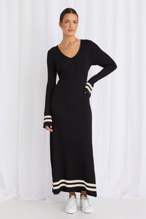 Model wears a long sleeve black maxi dress