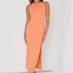 model in orange ribbed midi dress and heels