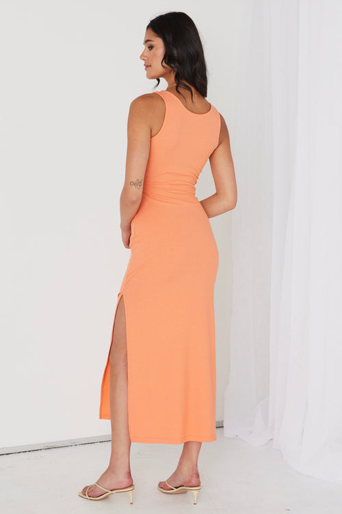 model in orange ribbed midi dress and heels