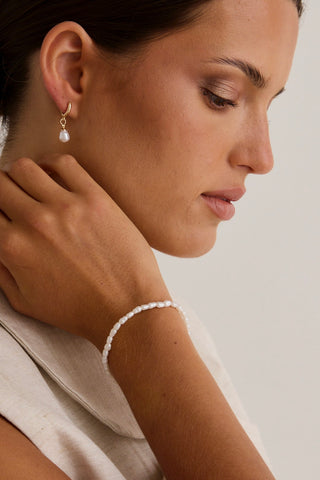 model wears a pearl bracelet