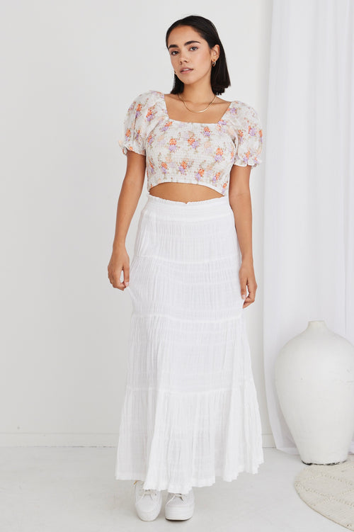 model in floral cream crop top and white maxi skirt