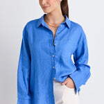 model wears a blue linen shirt