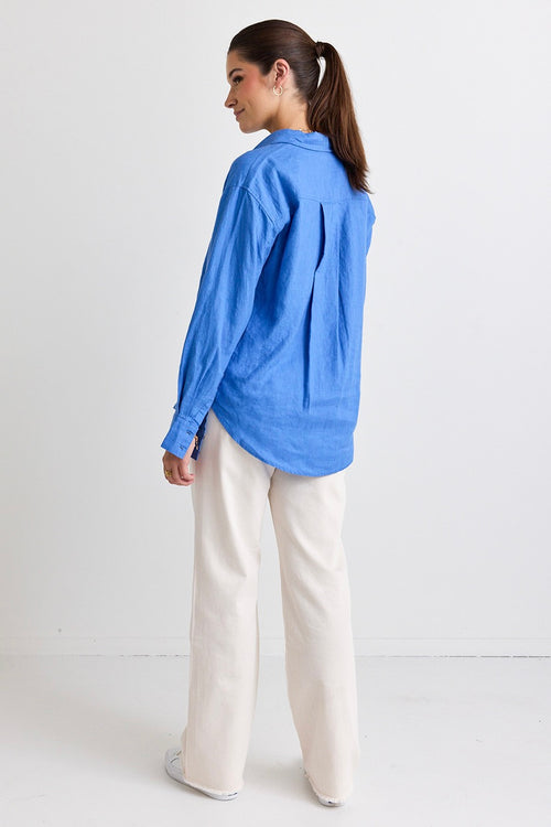 model wears a blue linen shirt