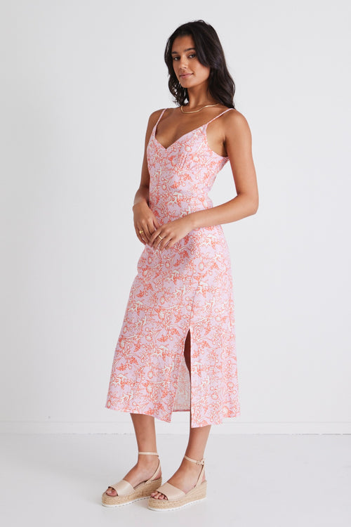 Model wears a pink slip midi dress