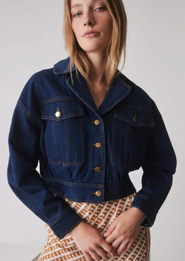 model wears a blue denim jacket