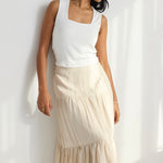 model wears a beige linen skirt