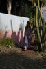 model wears a pink and blue check maxi dress