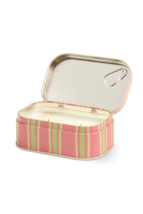 A rectangular tin candle with its lid open, featuring a pink and light green striped exterior, white wax inside, and a silver metal pull-tab lid.