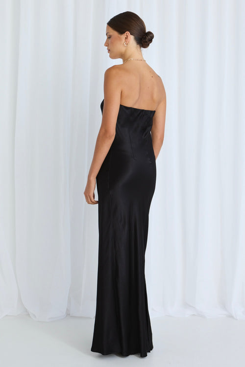 model wears a black strapless dress