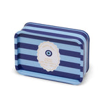 A rectangular tin of Incense + Smoke Eye Blue Stripe 184g Tin Candle, featuring a blue and navy striped pattern with a central cream-colored circular label containing an evil eye design.