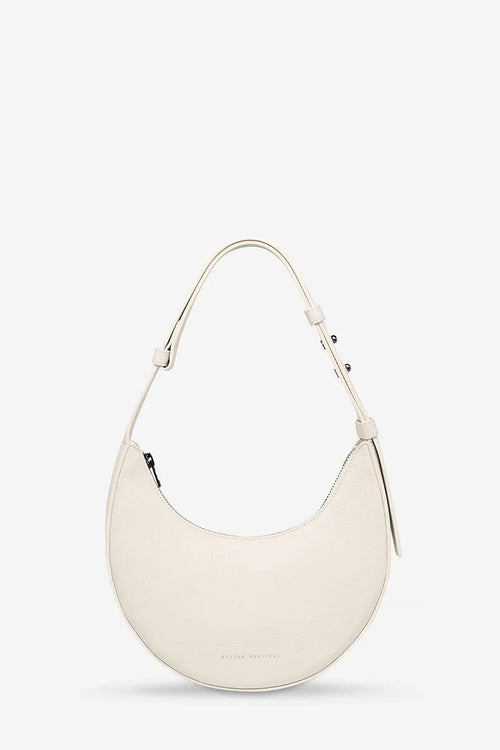 White handbag on a light beige background