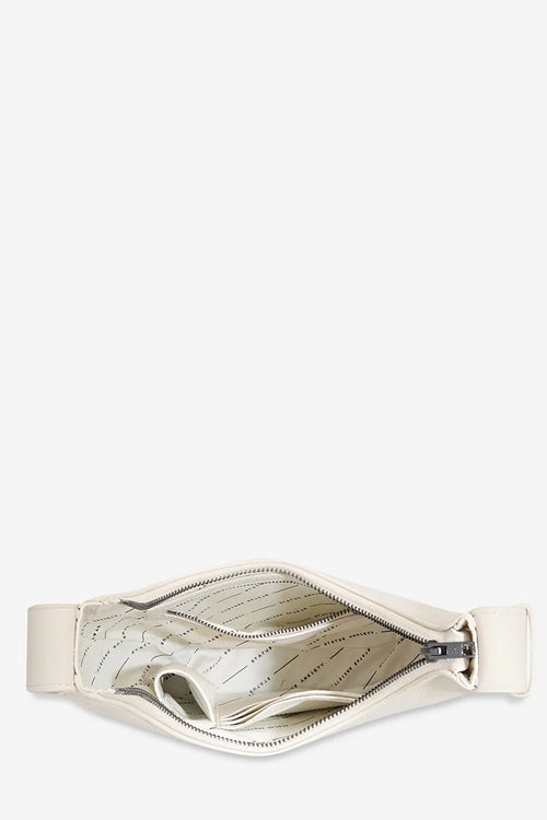 An off-white leather pouch shown from a top-down view, open to reveal a patterned interior lining, set against a solid off-white background.