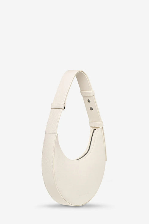 White handbag on a light gray background