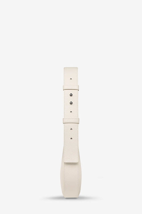 A cream-colored leather belt with silver-tone metal hardware, shown vertically against a plain white background.