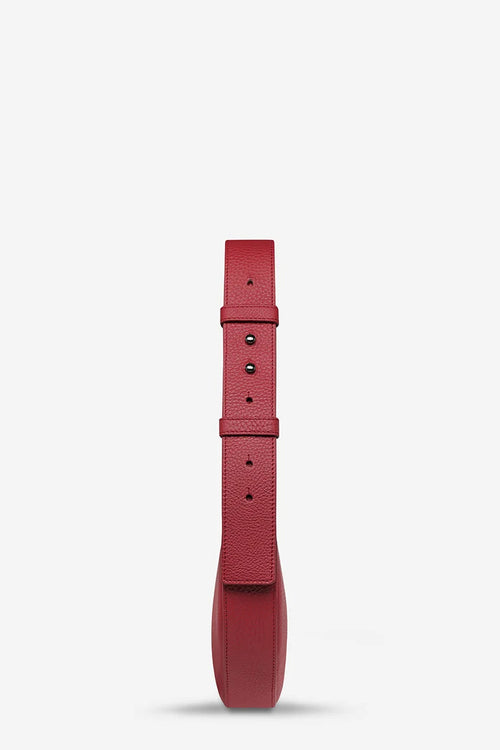 A single red textured leather watch strap shown vertically against a clean white background.