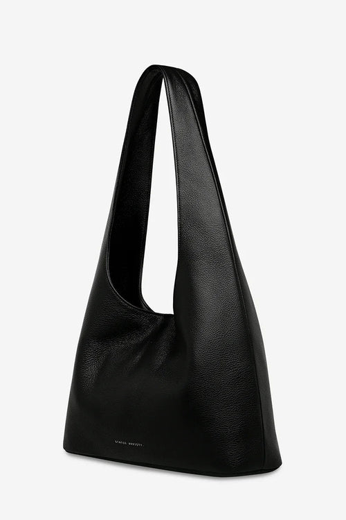 Black shoulder bag on a light gray background
