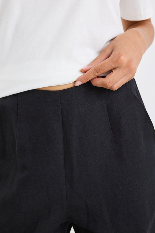 model wears a black linen wide leg pant and a white t-shirt