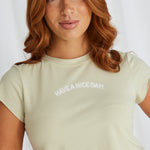 model in light green crop top