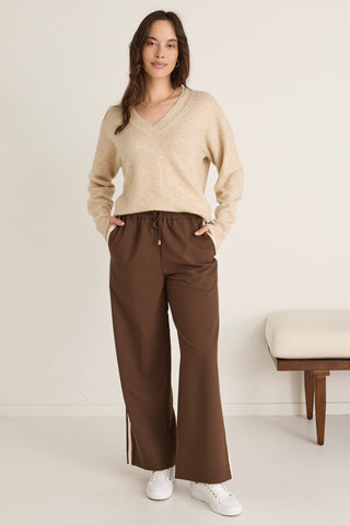 model wears brown jogger pants