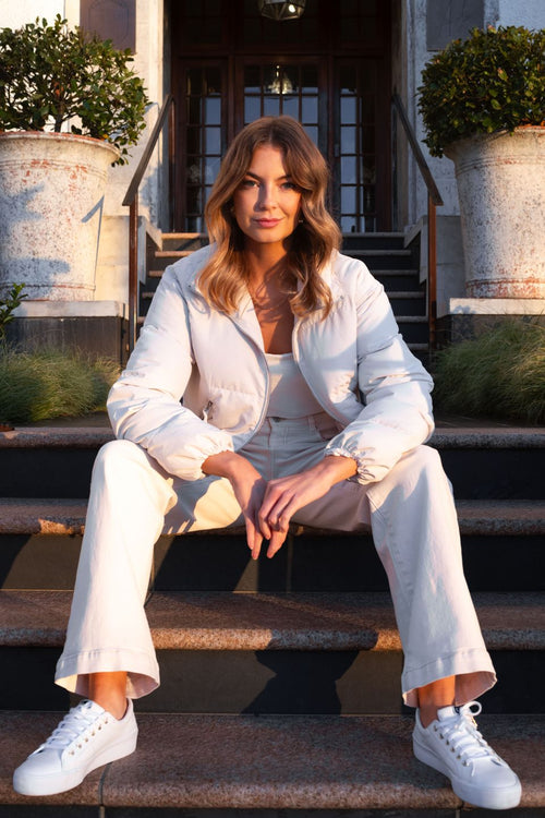 model wears a white puffer jacket