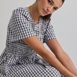 model wears a black gingham midi dress