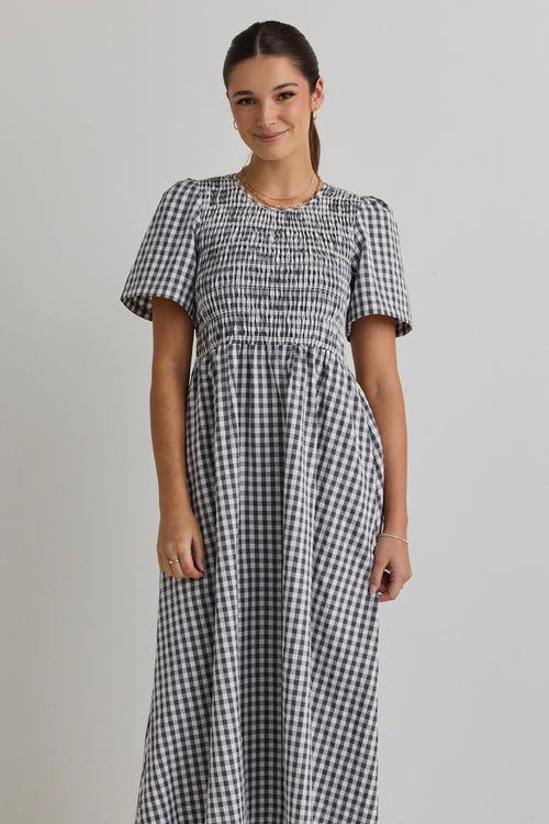 model wears a black gingham midi dress