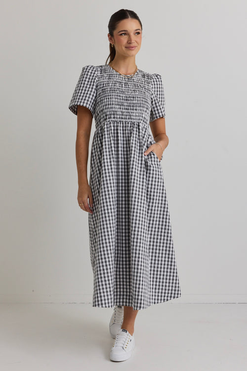 model wears a black gingham midi dress