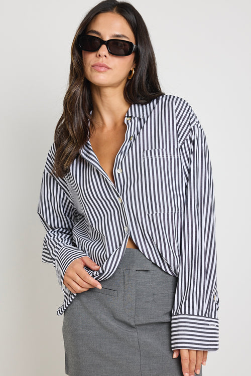 model wears a black and white stripe shirt